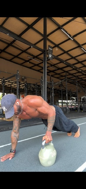 Benjamin progressing a kettlebell renegade row